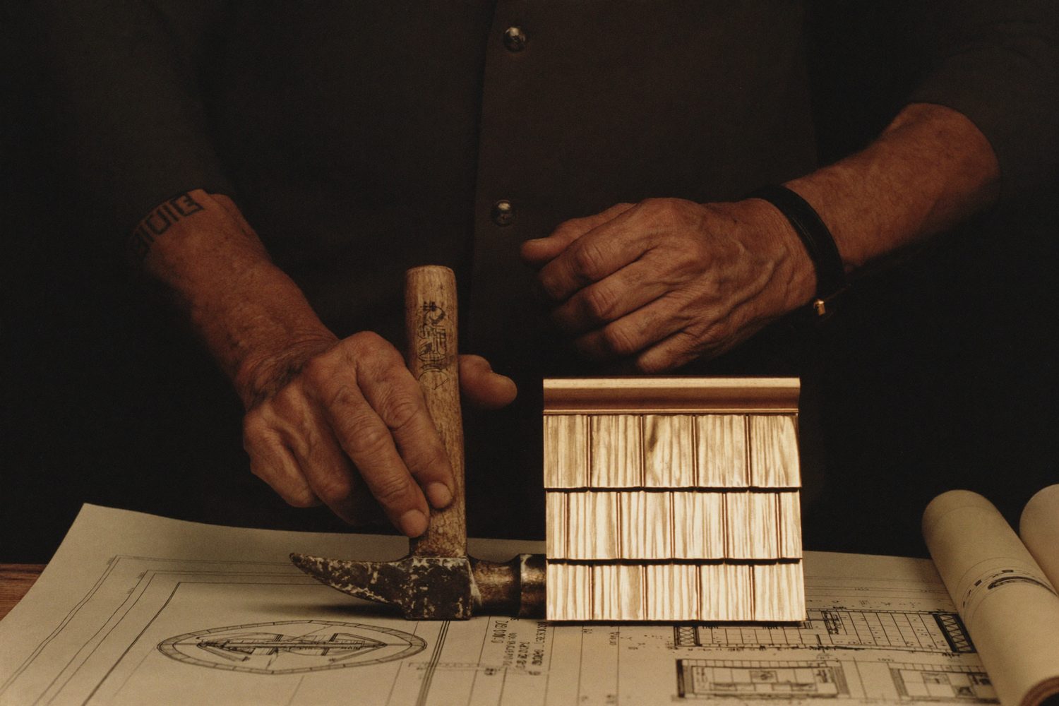 Hands of an Arthur's Roofing craftsman at work — the legacy of family craftsmanship since 1992